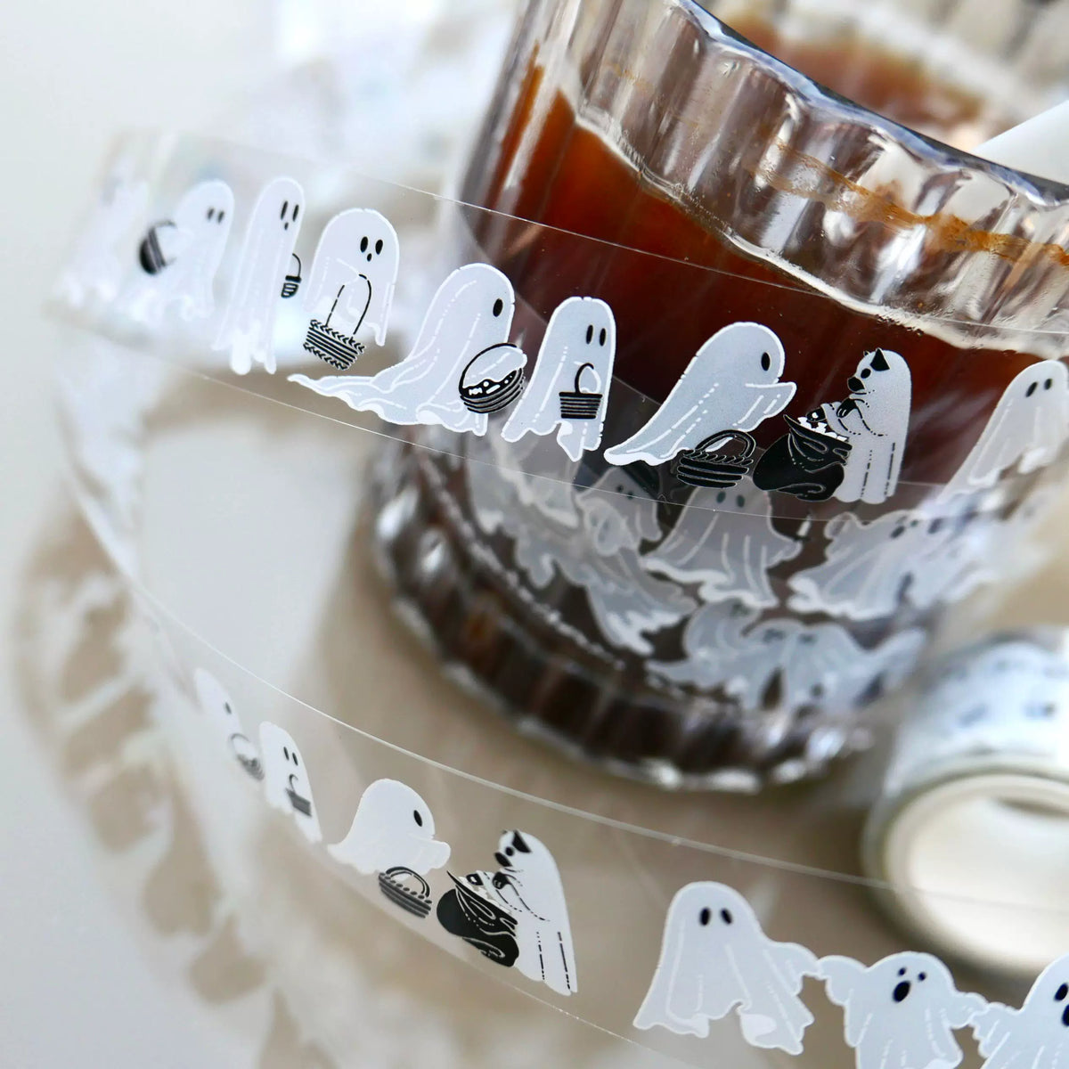 Ghost tape roll and strip wrapped around a ribbed glass