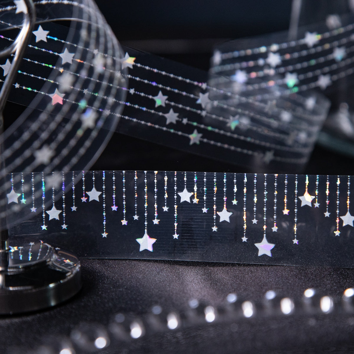 Close-up of hanging star garland tape with holographic shimmer