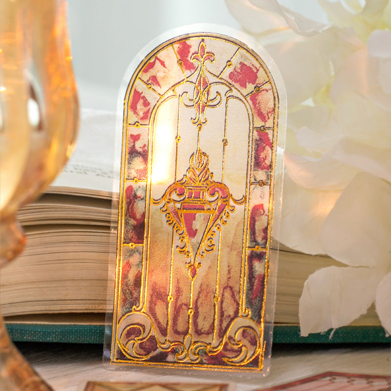 Single arched stained glass sticker with warm pink and gold ornamental window design