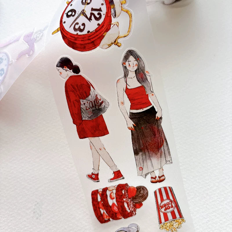 Die-cut red-themed girls and keepsakes tape pieces layered on white paper
