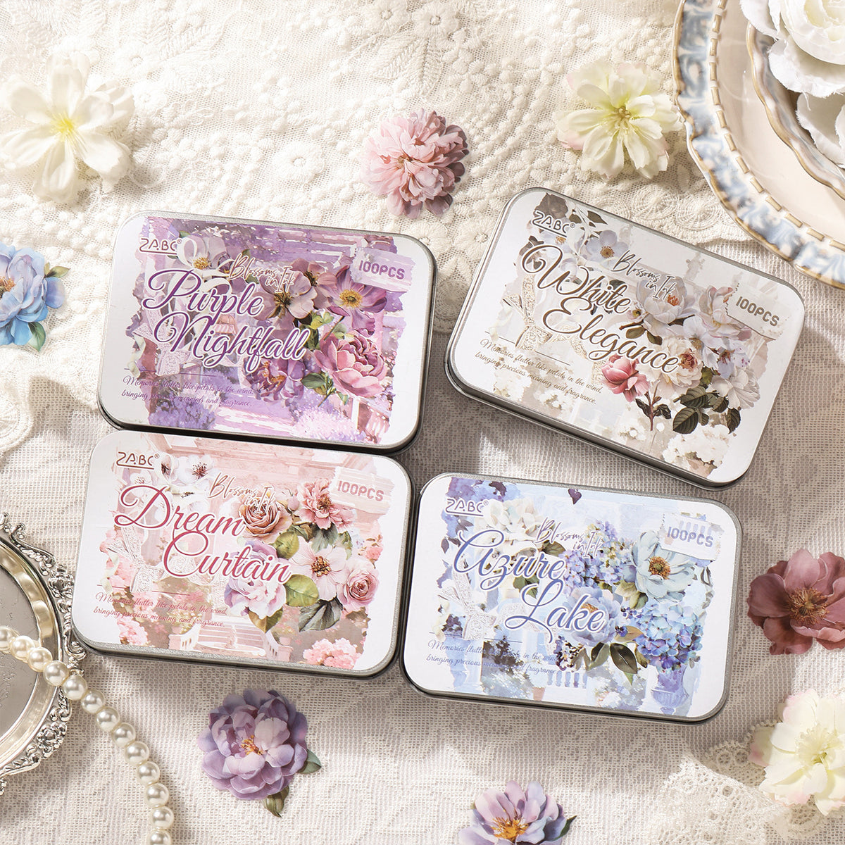 Four illustrated flower sticker tins with pearls and blooms