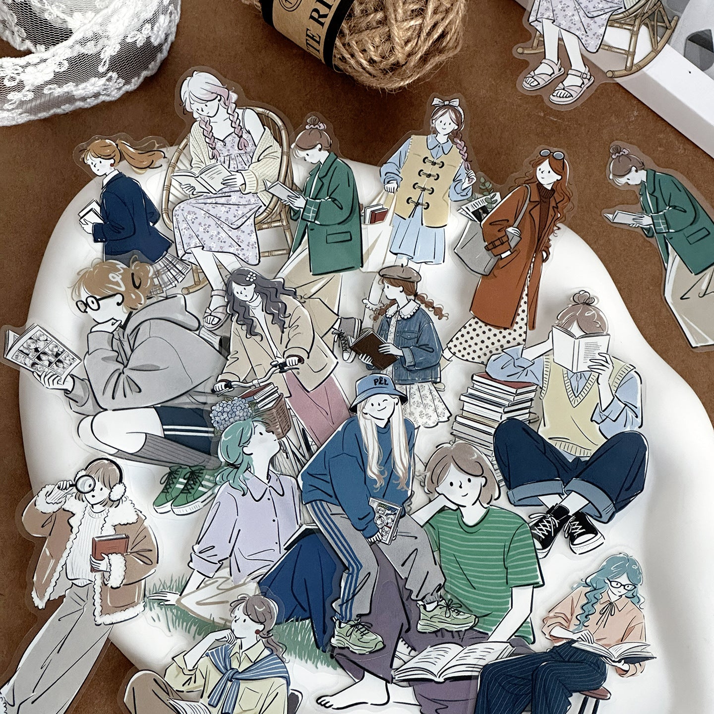 Soft girl character sticker pieces with modern outfits, seated poses, and casual fashion figures