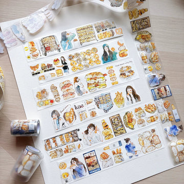 Bakery girl tape strips laid out on white paper with tape rolls