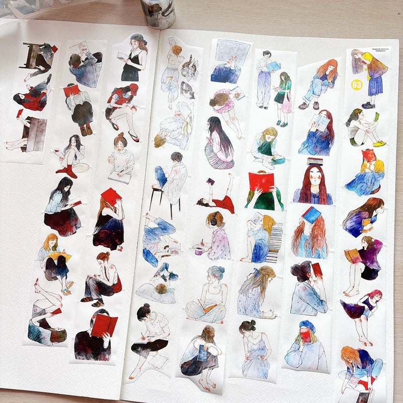 Book lover girls tape strips laid out in a journal