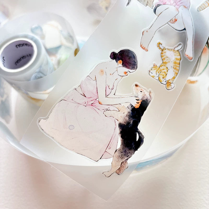 Die-cut girls hugging cats and dogs tape pieces layered on white paper