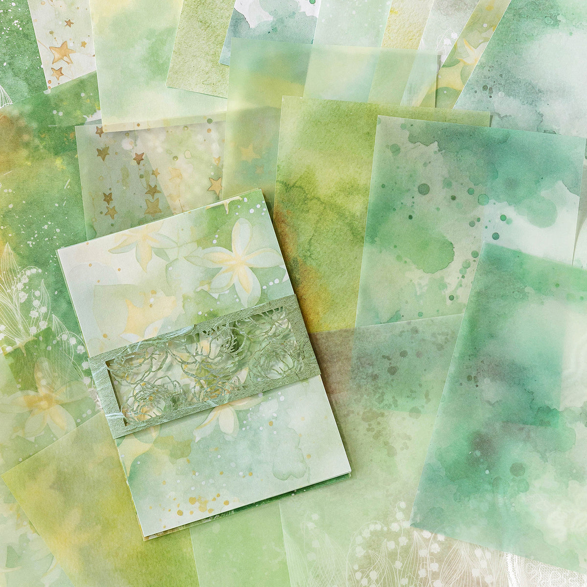 Watercolor wash scrapbooking paper with die-cut lace floral border detail