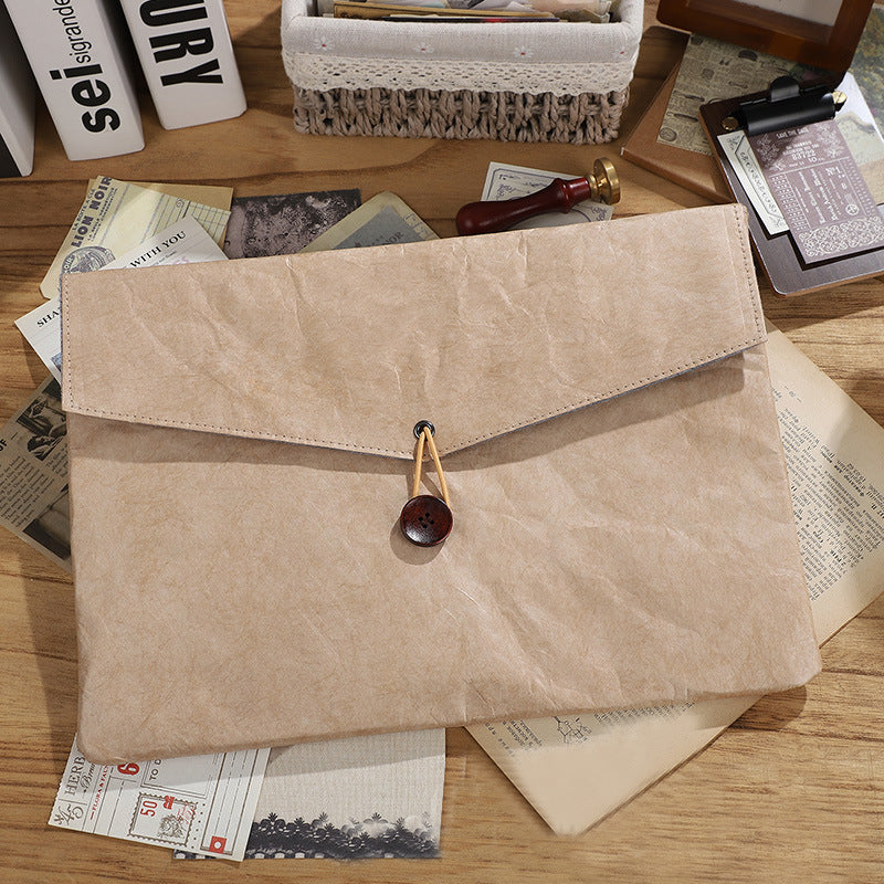 Kraft paper envelope folder with button closure, surrounded by stationery | Shroomi