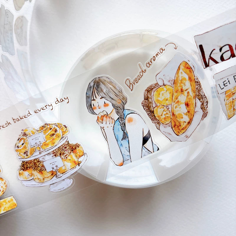 Die-cut bakery girls and bread tape pieces layered on white paper