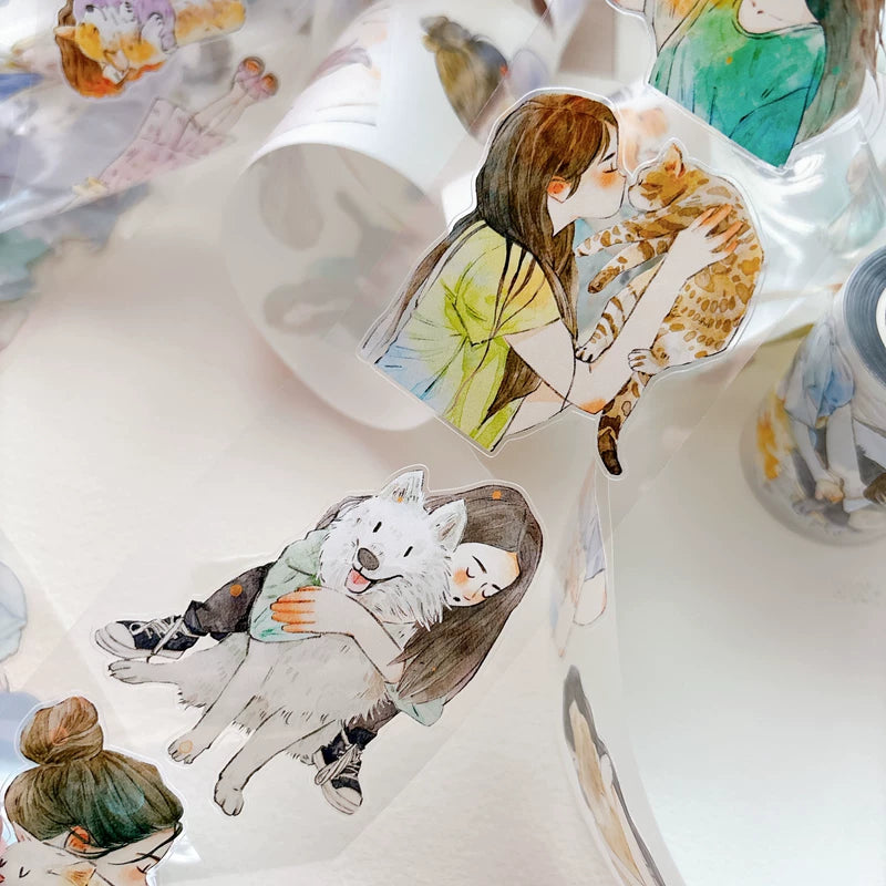 Close-up of die-cut girls hugging cats and dogs tape