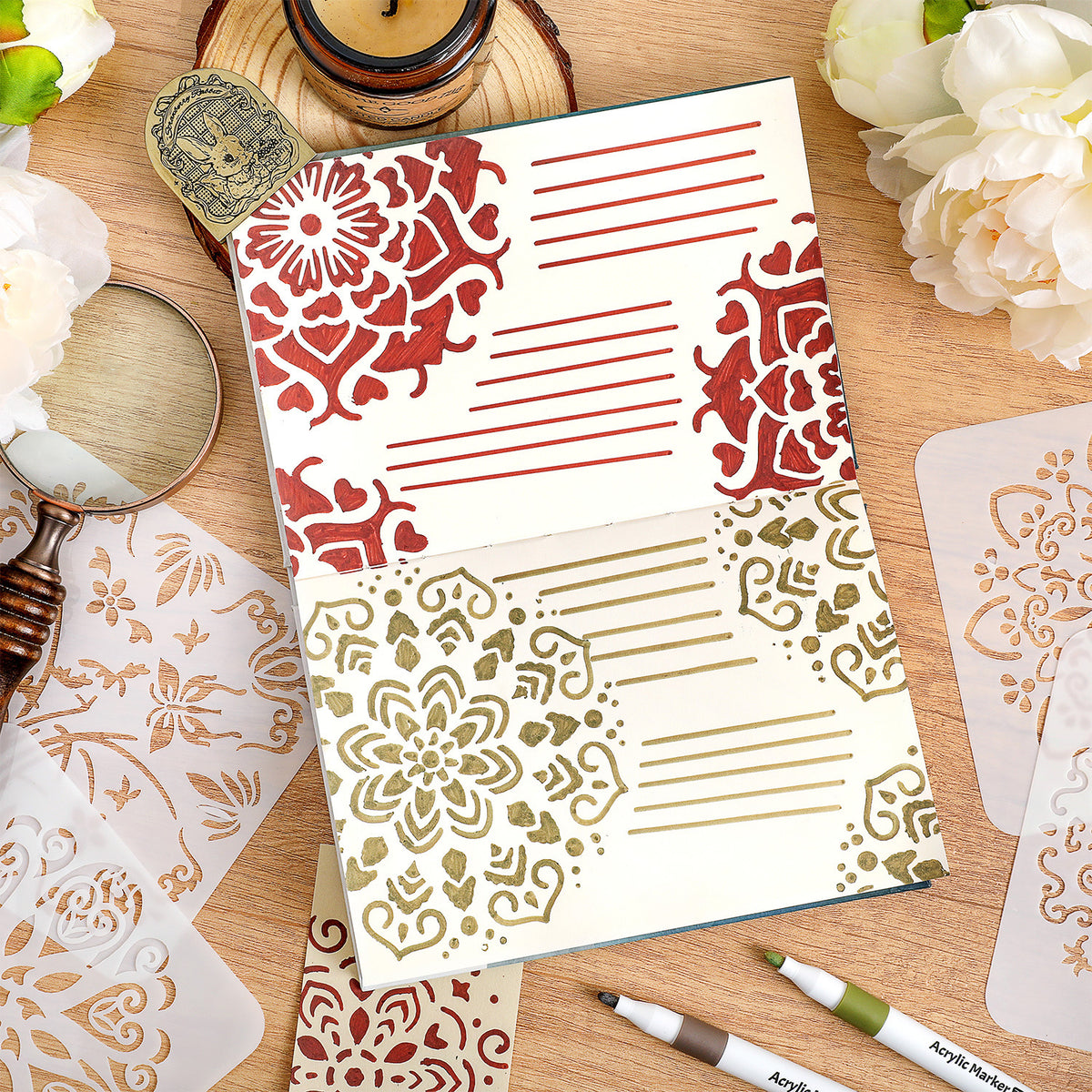 Journal page decorated with red and gold stenciled mandala patterns