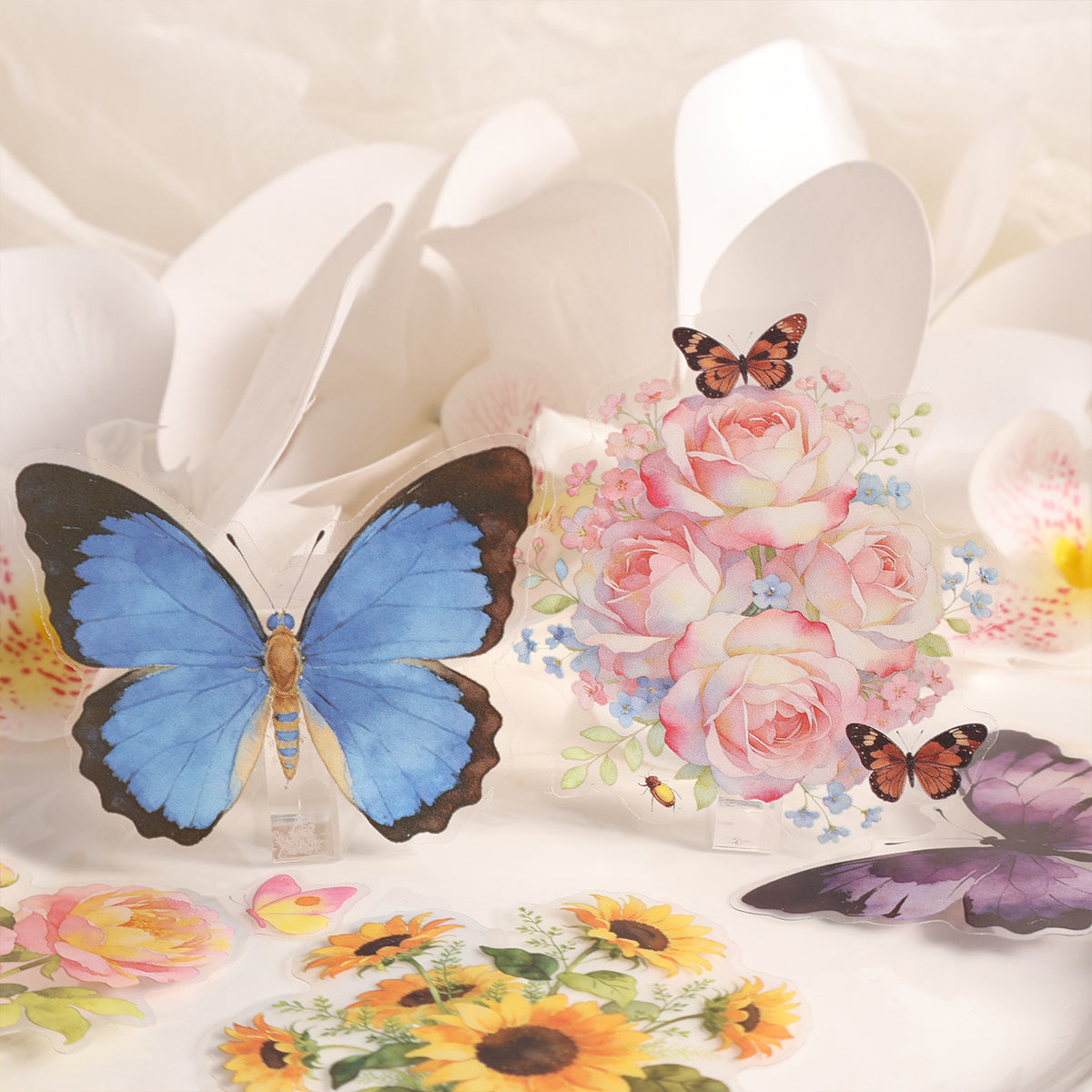 Blue butterfly PET sticker beside pink rose bouquet stickers