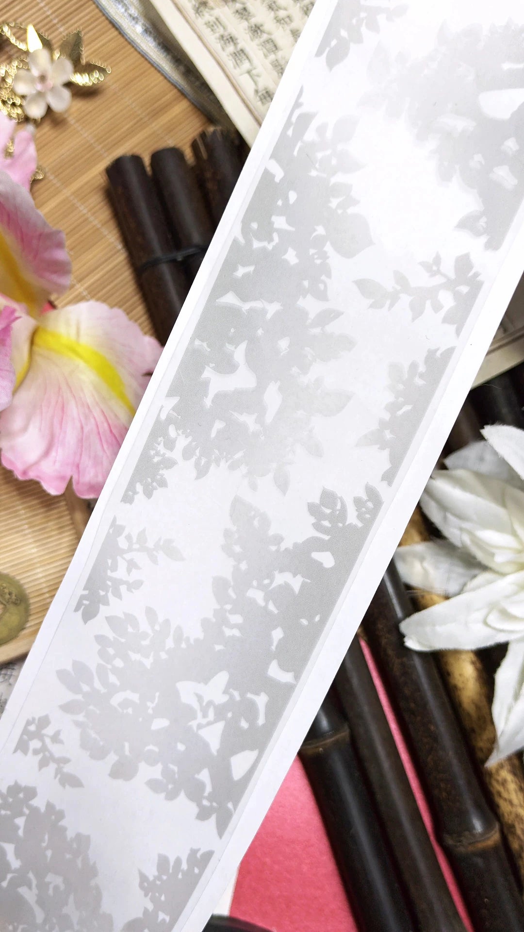Tree Shadow translucent PET tape close-up showing delicate tree canopy silhouettes on semi-transparent base, styled with pink petals and bamboo