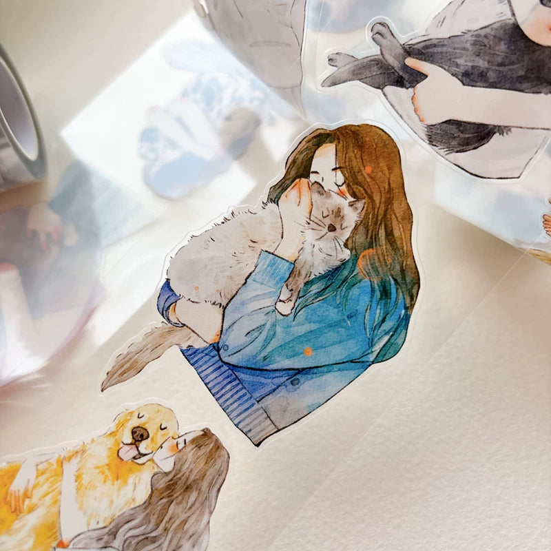 Close-up of die-cut girls hugging cats and dogs tape