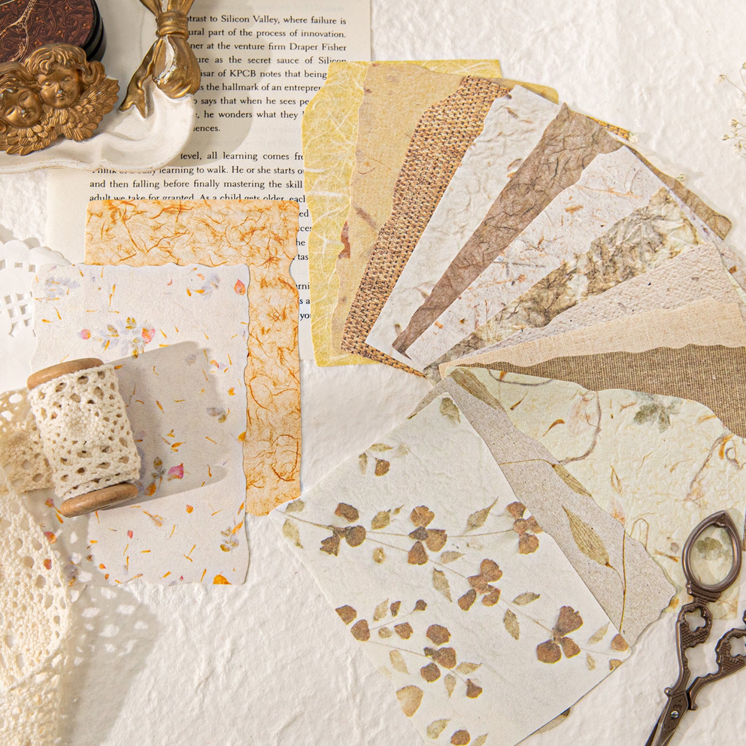 Vintage embossed scrapbooking paper pack with textured neutral sheets