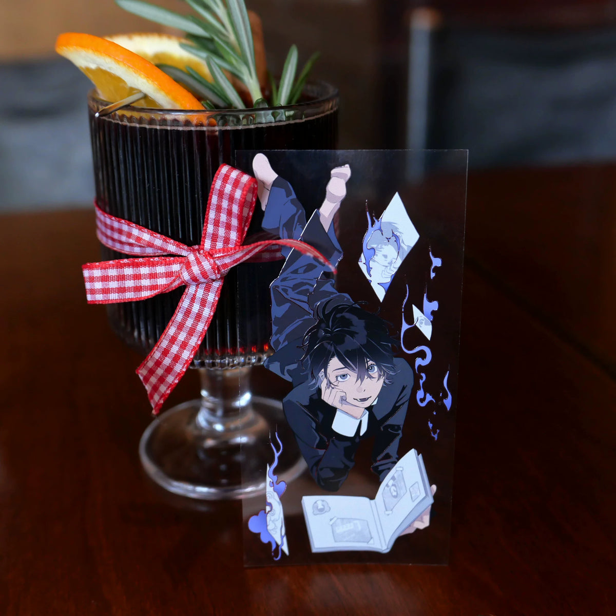 Cut washi tape piece of a boy lying with a book, tied to a glass