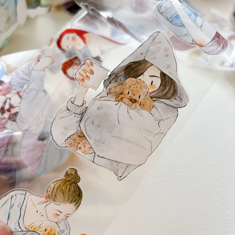 Close-up of die-cut girls hugging cats and dogs tape