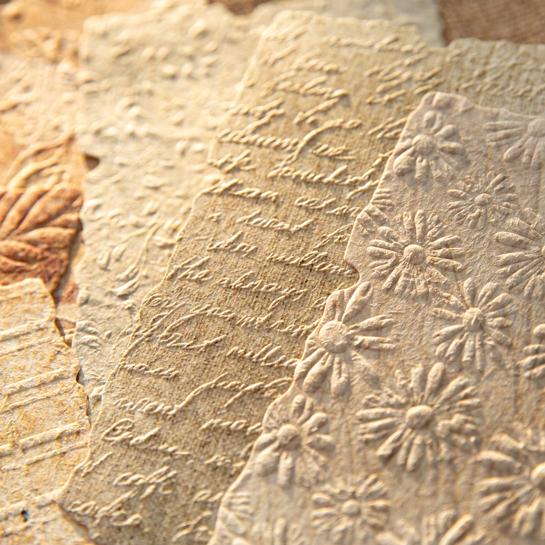 Vintage embossed scrapbooking paper pack with textured neutral sheets