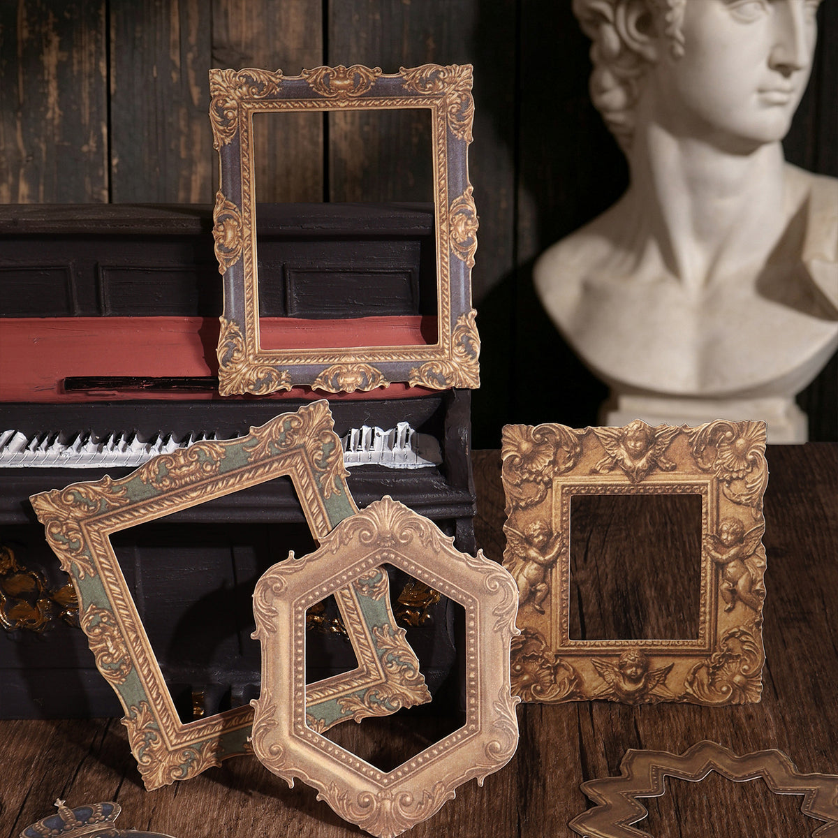 Gilded and bronze frame stickers arranged beside a classical bust and piano