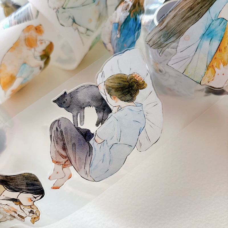Die-cut girls hugging cats and dogs tape pieces layered on white paper