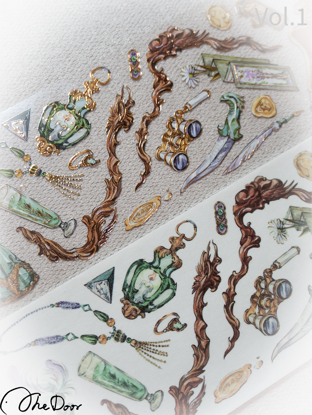 Close-up of perfume bottles, binoculars and ornate scrolls on washi tape