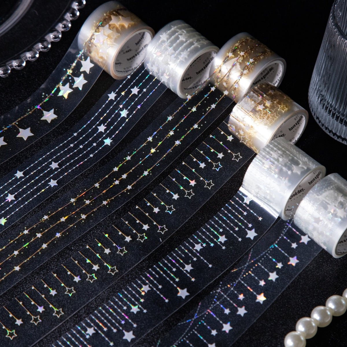 Star fairy light PET tape rolls and strips on a dark background