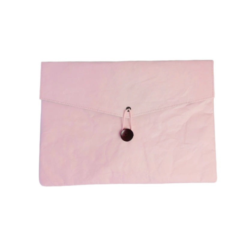 Pink paper clutch with a dark button closure | Shroomi