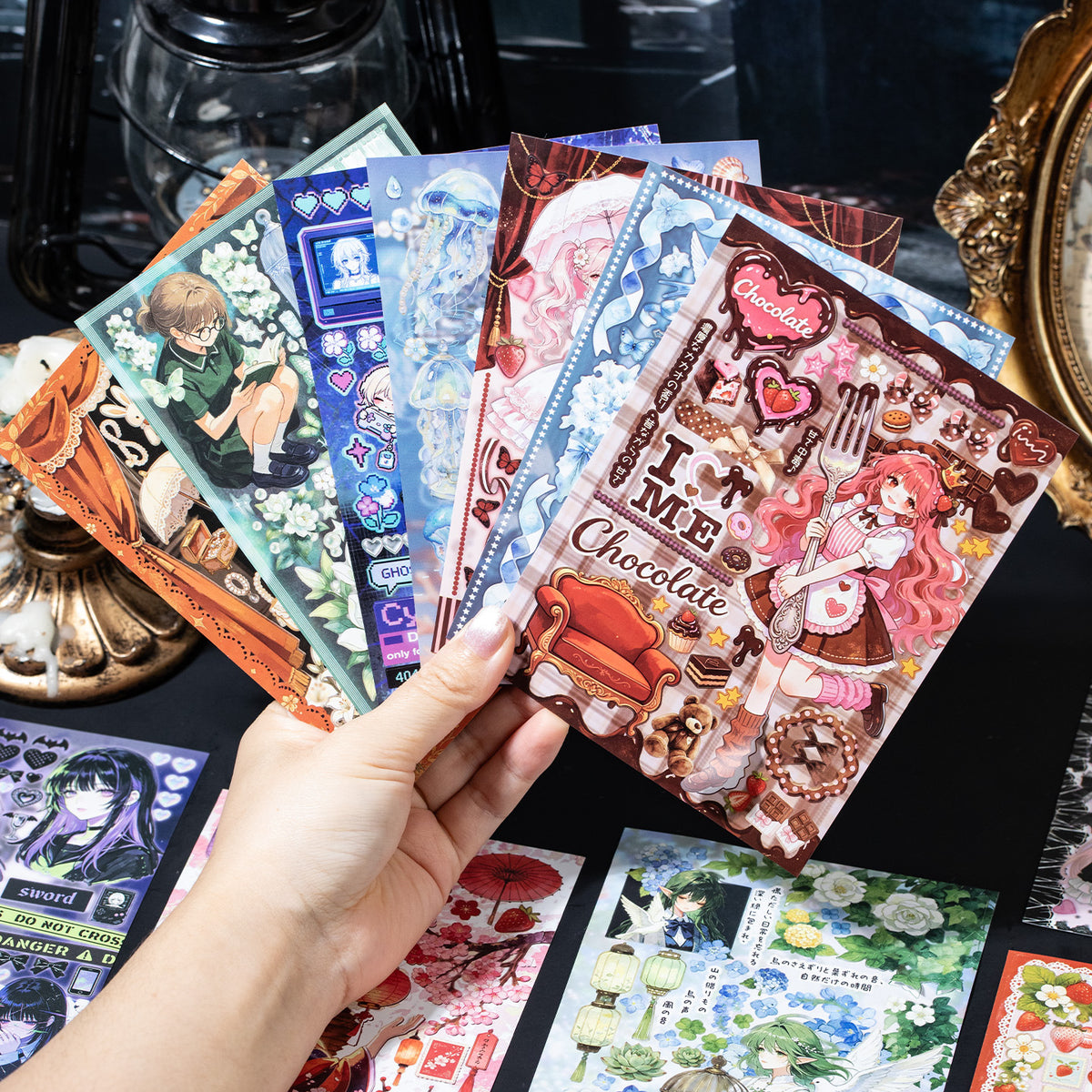 Hand fanning anime character sticker sheets