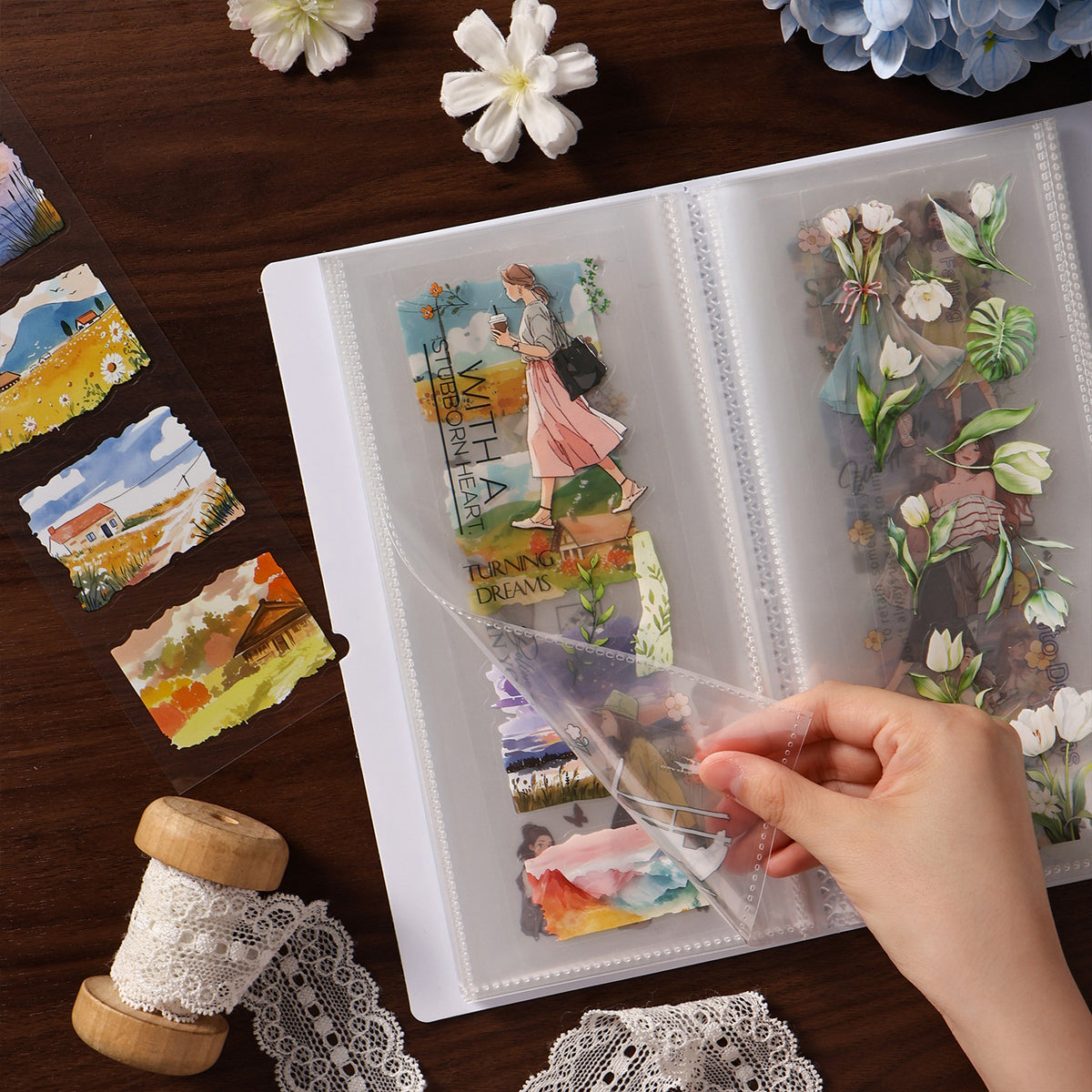 Clear storage album holding washi tape samples and stickers, pages being flipped by hand