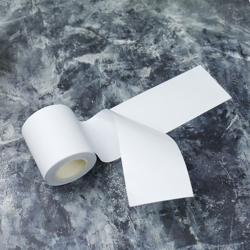 White base tape with release paper, showcasing a clean, smooth strip ideal for crafting and adhesive applications.