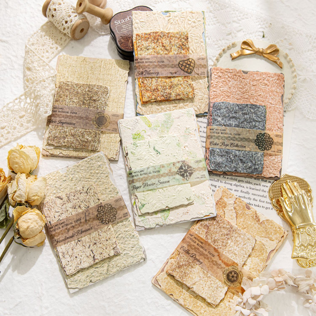 Vintage embossed scrapbooking paper pack with textured neutral sheets