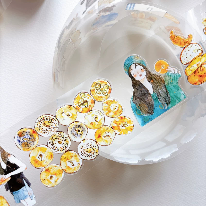 Close-up of die-cut bakery girls and bread tape
