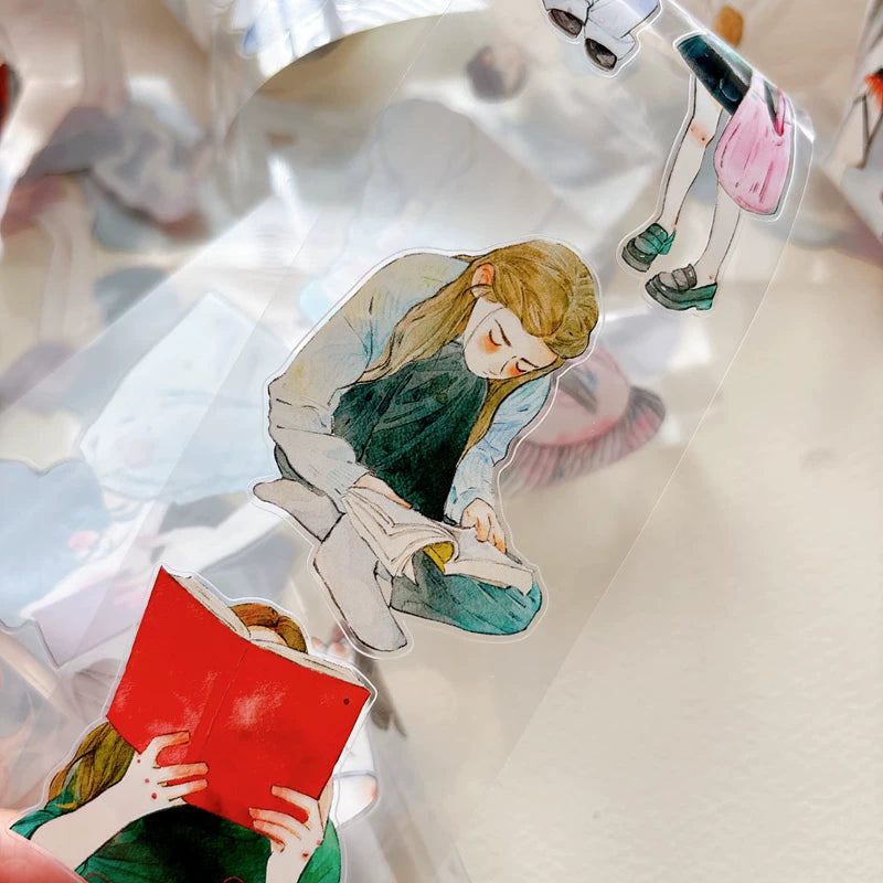 Close-up of die-cut girls reading books tape