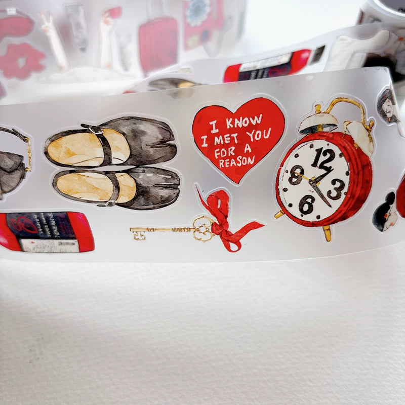 Close-up of die-cut red-themed girls and keepsakes tape