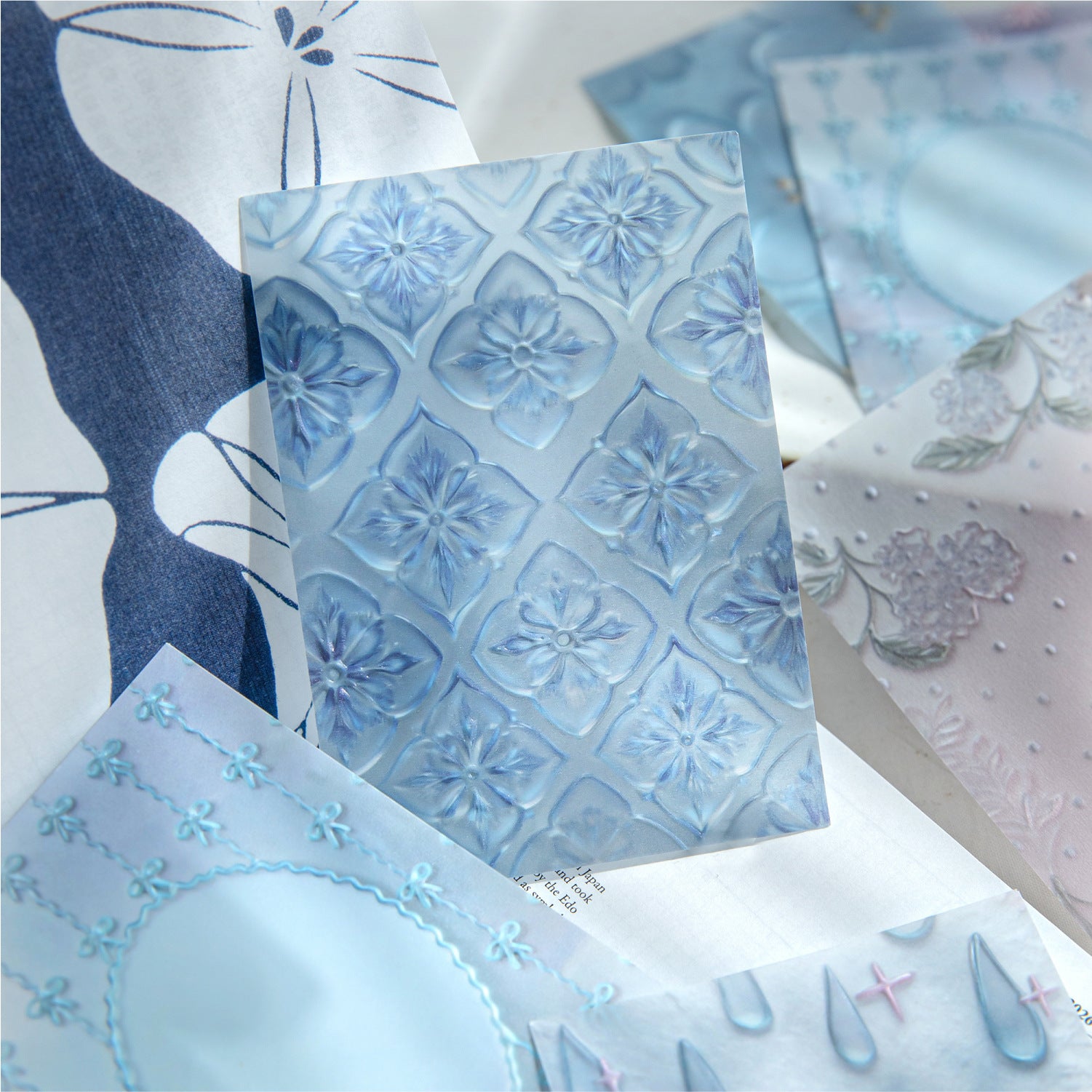 Embossed vellum scrapbooking paper with translucent decorative sheets