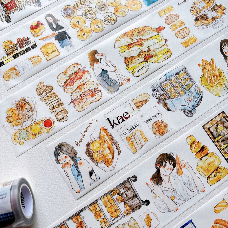 Die-cut bakery girls and bread tape pieces layered on white paper
