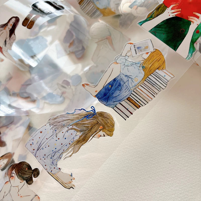 Close-up of die-cut girls reading books tape