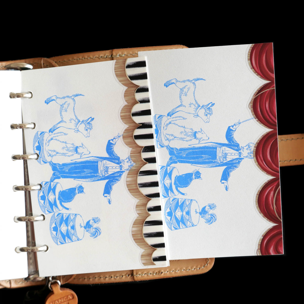 Planner pages trimmed with striped and red curtain tape