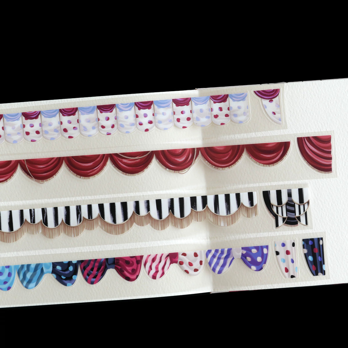 Four strips of die-cut curtain tape: polka-dot, red drape, striped and colorful valances
