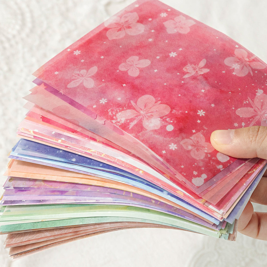 Watercolor wash scrapbooking paper with die-cut lace floral border detail