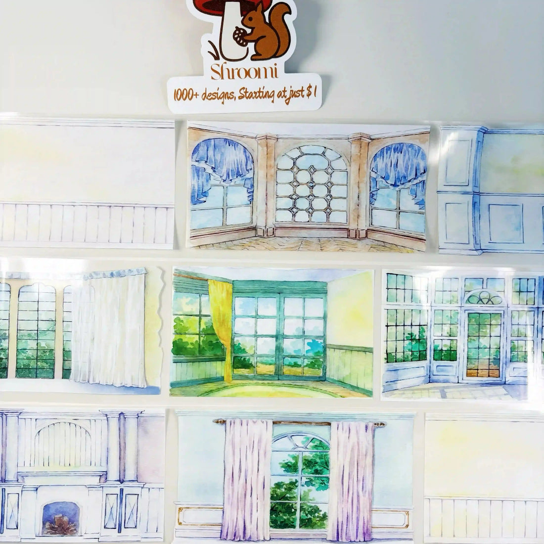 Wall Works tape strips displayed on a surface — ornate window panels, curtained arched windows, and interior wall scene variations