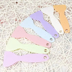 Handy plastic spatula designed to flatten stickers, ensuring smooth application with no lifted edges.