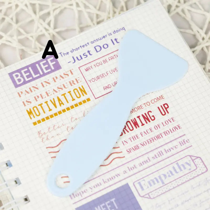 Handy plastic spatula designed for flattening stickers, ensuring a smooth, edge-free application on any surface.