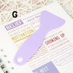 Handy plastic spatula in action, smoothing a vibrant sticker onto a surface with precision to ensure a flawless finish.