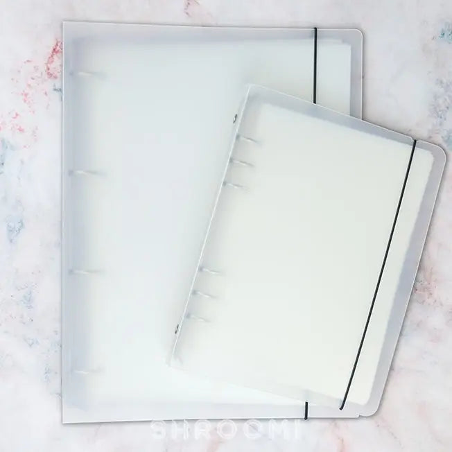 Colorful washi tape storage album with clear pocket pages for organizing pre-cut tape pieces and stickers neatly.