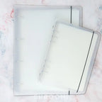 Colorful washi tape storage album with clear pocket pages for organizing pre-cut tape pieces and stickers neatly.