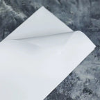 White base tape with release paper, featuring a clean, smooth texture and a protective backing for easy application.