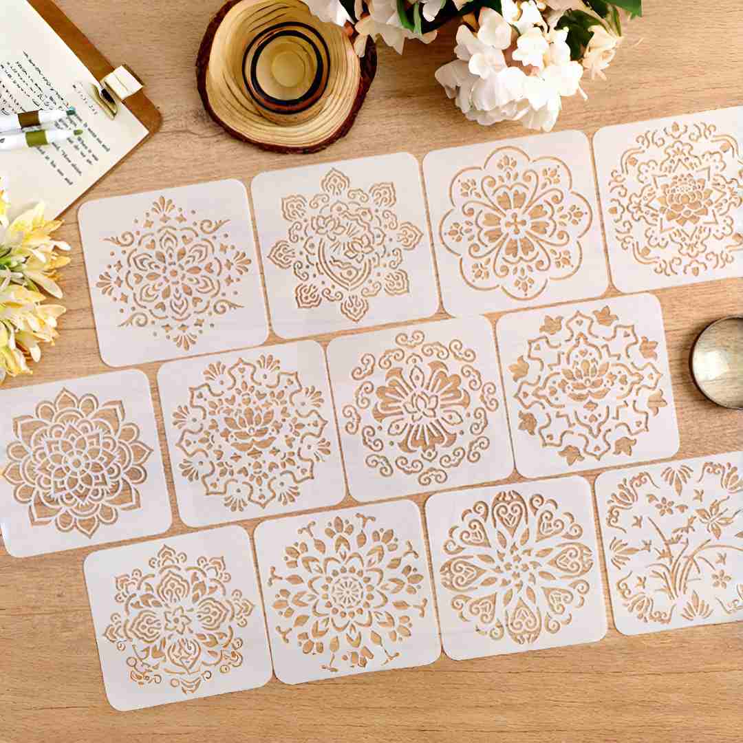 Twelve square mandala drawing stencils laid out on a wooden desk