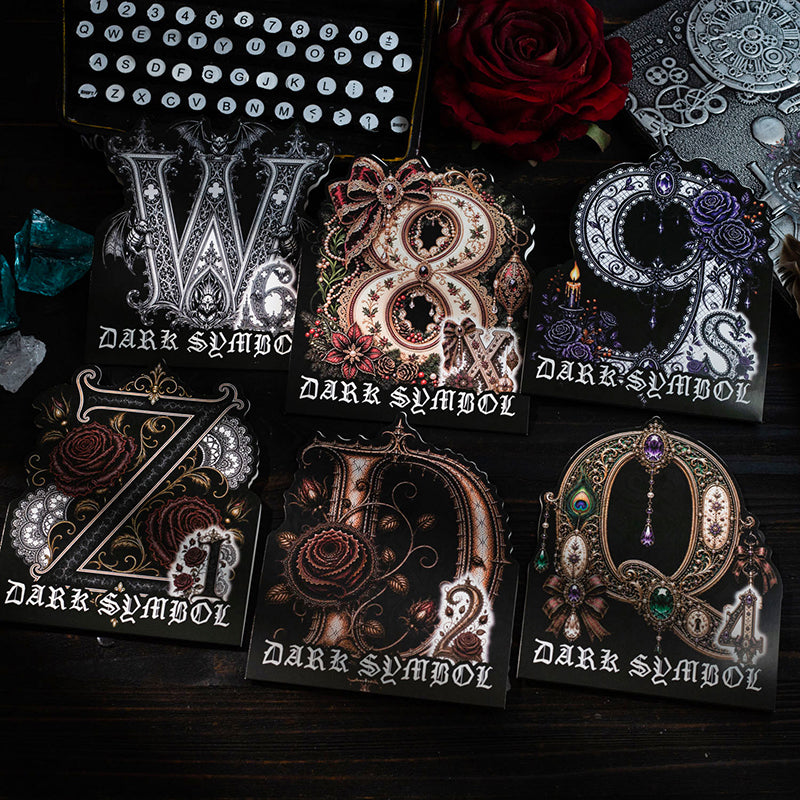 Gothic letter stickers with roses and gems on a dark background