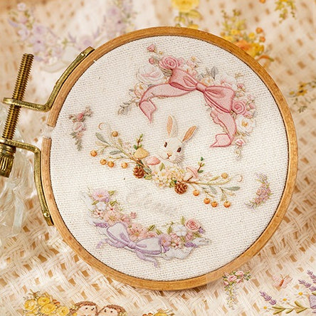Floral embroidery frame sticker book with botanical borders, wreaths, rabbits, butterflies, ribbons, and photo frame designs