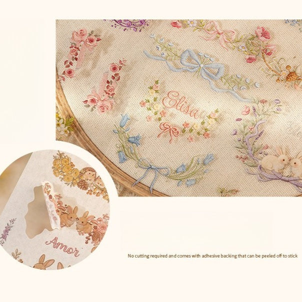 Floral embroidery frame sticker book with botanical borders, wreaths, rabbits, butterflies, ribbons, and photo frame designs